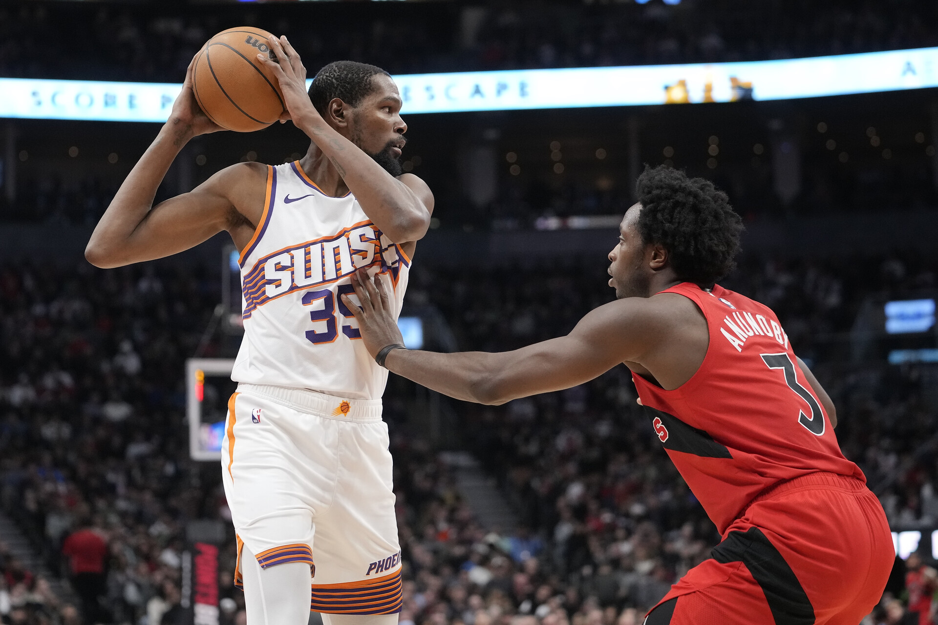 Nov 29, 2023; Toronto, Ontario, CAN; Phoenix Suns forward Kevin Durant (35) keeps the ball away from Toronto Raptors forward O.G. Anunoby (3) during the first half at Scotiabank Arena.