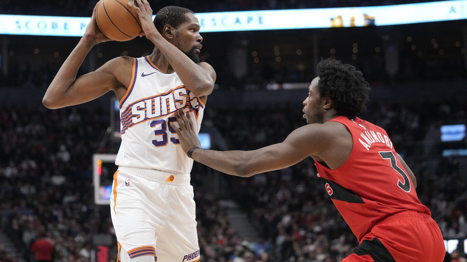 Nov 29, 2023; Toronto, Ontario, CAN; Phoenix Suns forward Kevin Durant (35) keeps the ball away from Toronto Raptors forward O.G. Anunoby (3) during the first half at Scotiabank Arena.