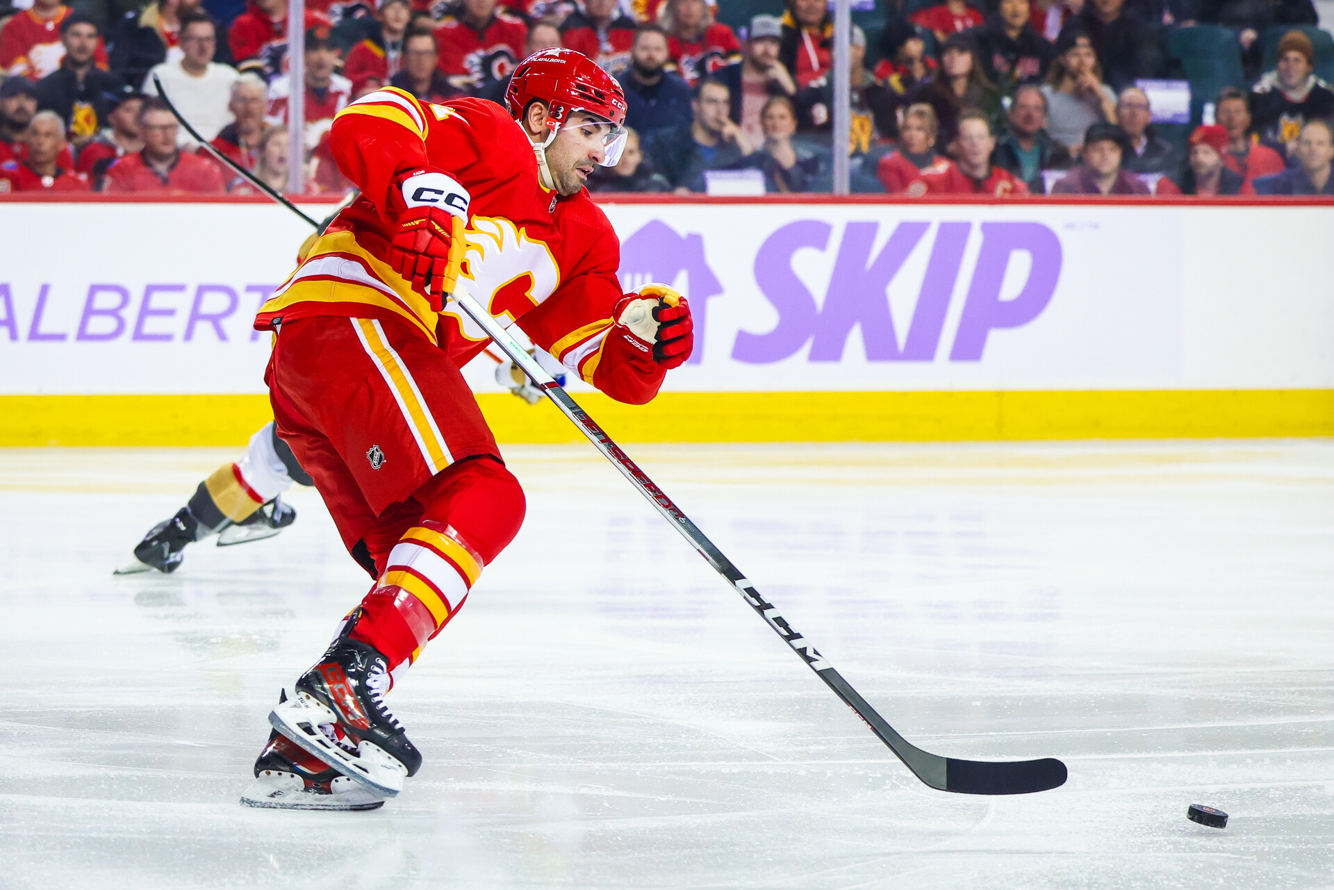 Nov 27, 2023; Calgary, Alberta, CAN; Calgary Flames center Nazem Kadri (91) skates with the puck against the Vegas Golden Knights during the first period at Scotiabank Saddledome