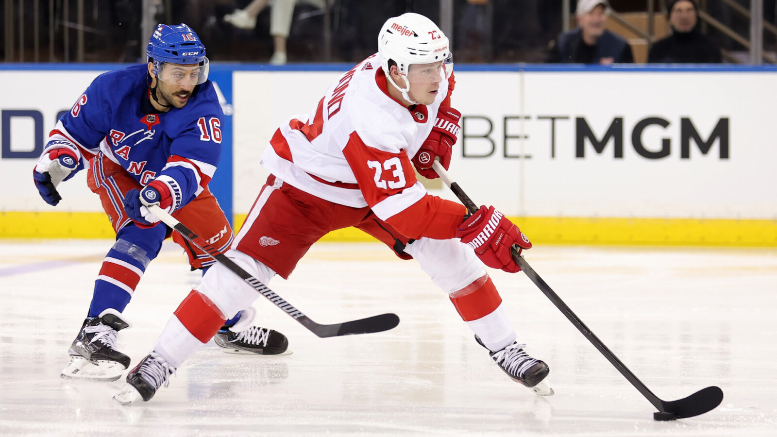 Nov 29, 2023; New York, New York, USA; Detroit Red Wings left wing Lucas Raymond (23) skates with the puck against New York Rangers center Vincent Trocheck (16) during the second period at Madison Square Garden