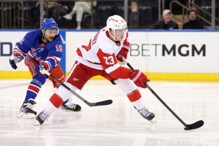 Nov 29, 2023; New York, New York, USA; Detroit Red Wings left wing Lucas Raymond (23) skates with the puck against New York Rangers center Vincent Trocheck (16) during the second period at Madison Square Garden
