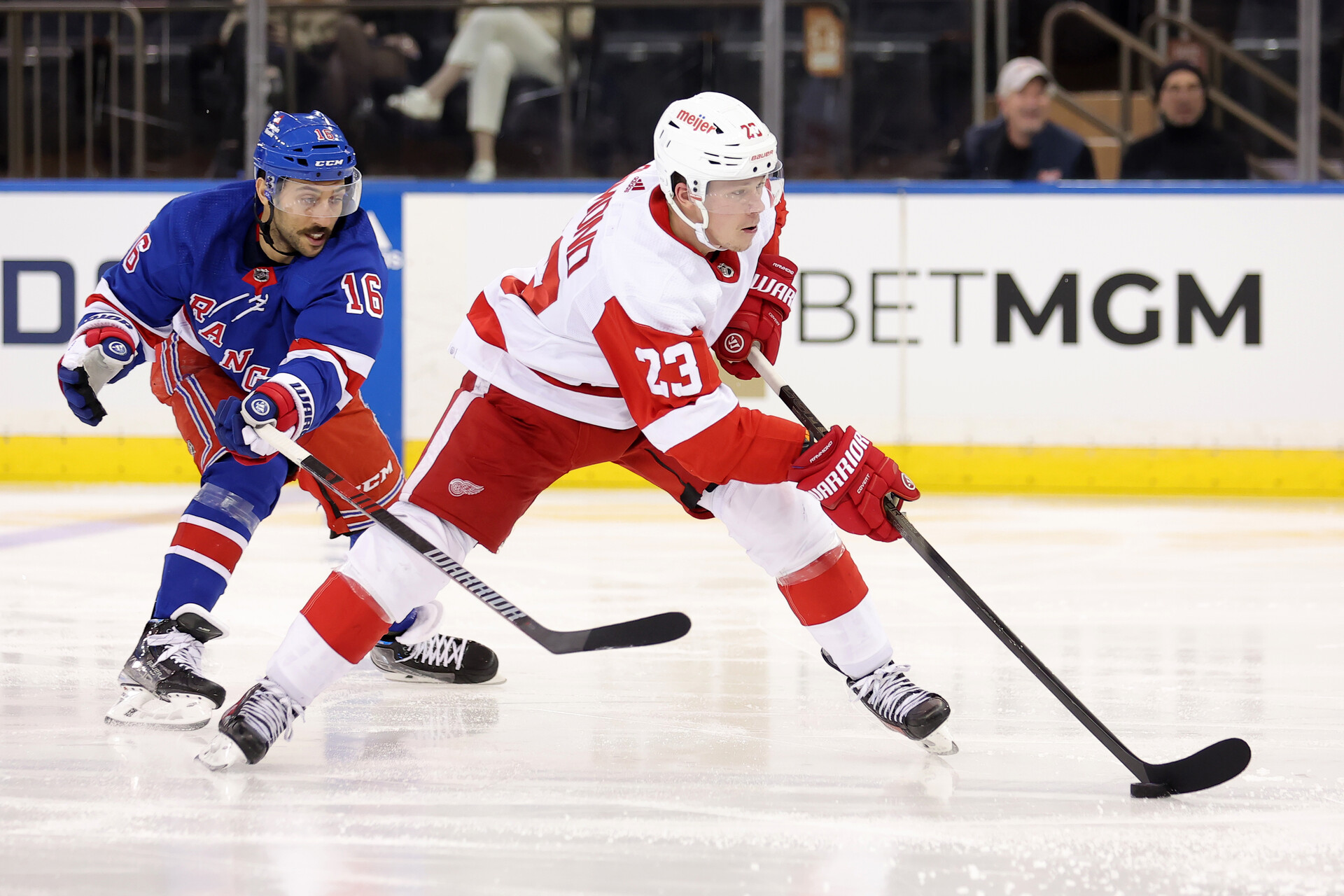 Nov 29, 2023; New York, New York, USA; Detroit Red Wings left wing Lucas Raymond (23) skates with the puck against New York Rangers center Vincent Trocheck (16) during the second period at Madison Square Garden