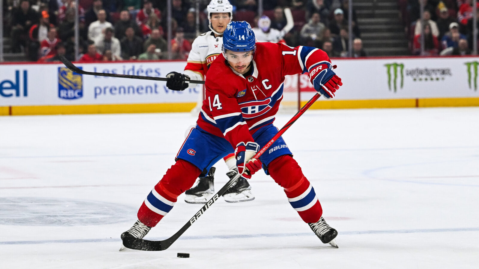 Nov 30, 2023; Montreal, Quebec, CAN; Montreal Canadiens center Nick Suzuki (14) plays the puck against the Florida Panthers during the second period at Bell Centre.