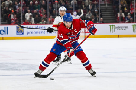 Nov 30, 2023; Montreal, Quebec, CAN; Montreal Canadiens center Nick Suzuki (14) plays the puck against the Florida Panthers during the second period at Bell Centre.