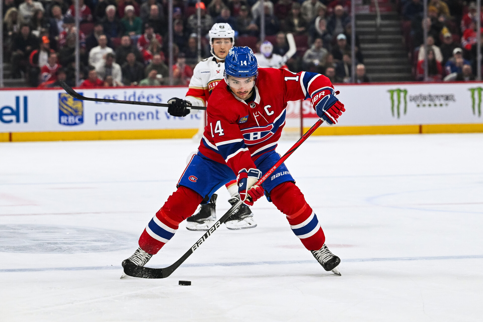 Nov 30, 2023; Montreal, Quebec, CAN; Montreal Canadiens center Nick Suzuki (14) plays the puck against the Florida Panthers during the second period at Bell Centre.