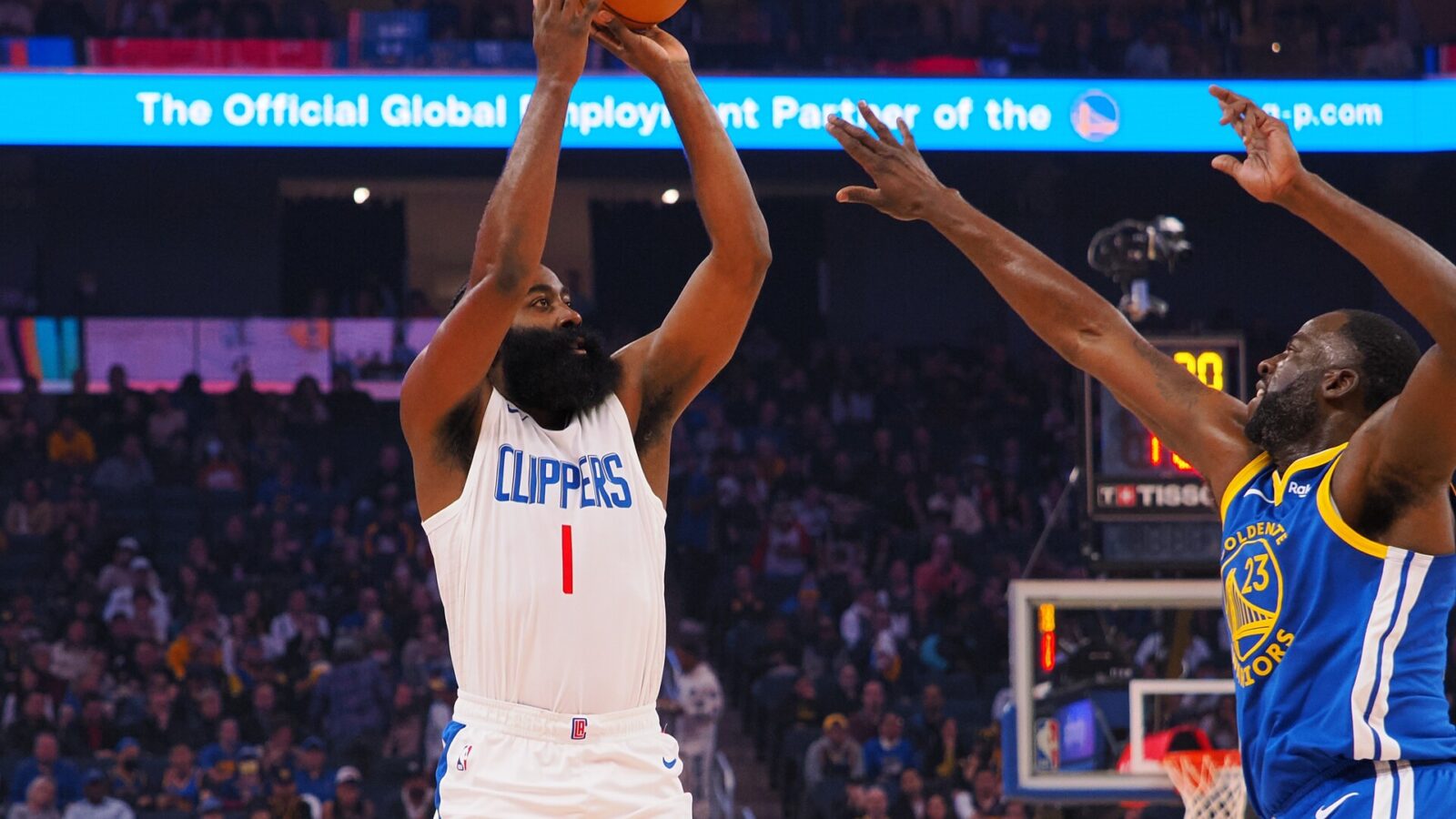 Nov 30, 2023; San Francisco, California, USA; Los Angeles Clippers guard James Harden (1) shoots the ball against Golden State Warriors forward Draymond Green (23) during the first quarter at Chase Center.
