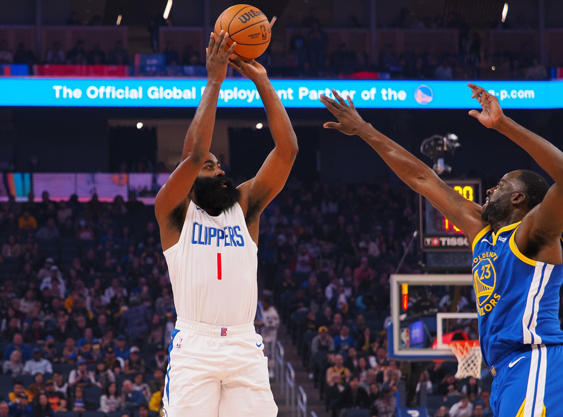 Nov 30, 2023; San Francisco, California, USA; Los Angeles Clippers guard James Harden (1) shoots the ball against Golden State Warriors forward Draymond Green (23) during the first quarter at Chase Center.
