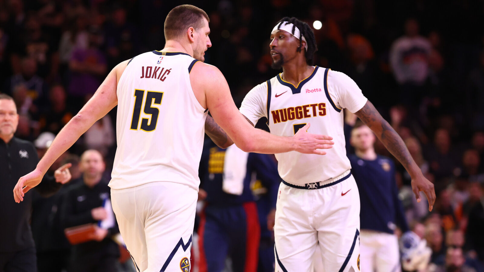 Dec 1, 2023; Phoenix, Arizona, USA; Denver Nuggets center Nikola Jokic (15) celebrates with guard Kentavious Caldwell-Pope (5) against the Phoenix Suns in the second half at Footprint Center.