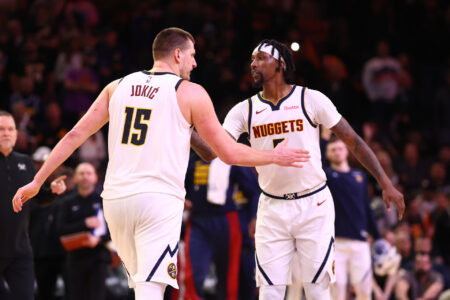 Dec 1, 2023; Phoenix, Arizona, USA; Denver Nuggets center Nikola Jokic (15) celebrates with guard Kentavious Caldwell-Pope (5) against the Phoenix Suns in the second half at Footprint Center.