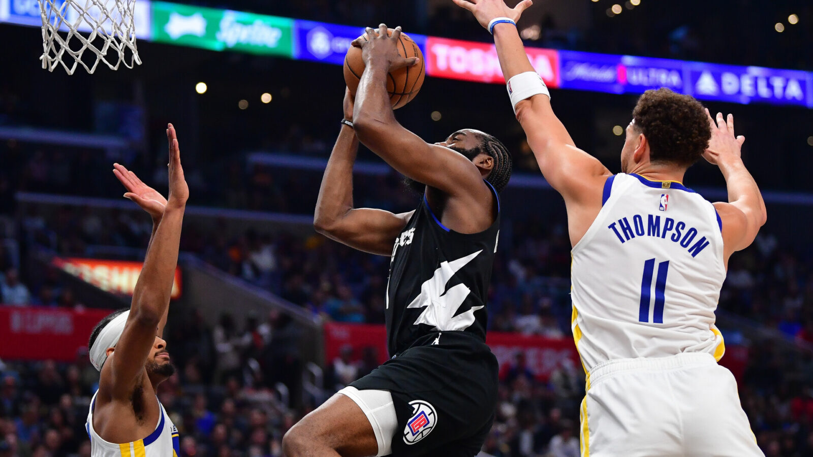 Dec 2, 2023; Los Angeles, California, USA; Los Angeles Clippers guard James Harden (1) moves to the basket against Golden State Warriors guard Klay Thompson (11) and forward Kevon Looney (5) during the second