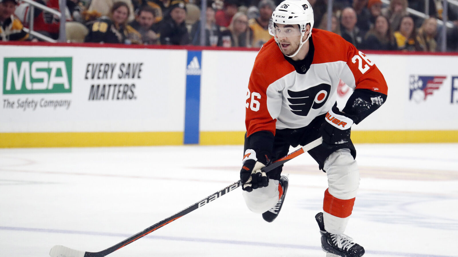 Philadelphia Flyers defenseman Sean Walker (26) skates with the puck against the Pittsburgh Penguins during the second period at PPG Paints Arena.