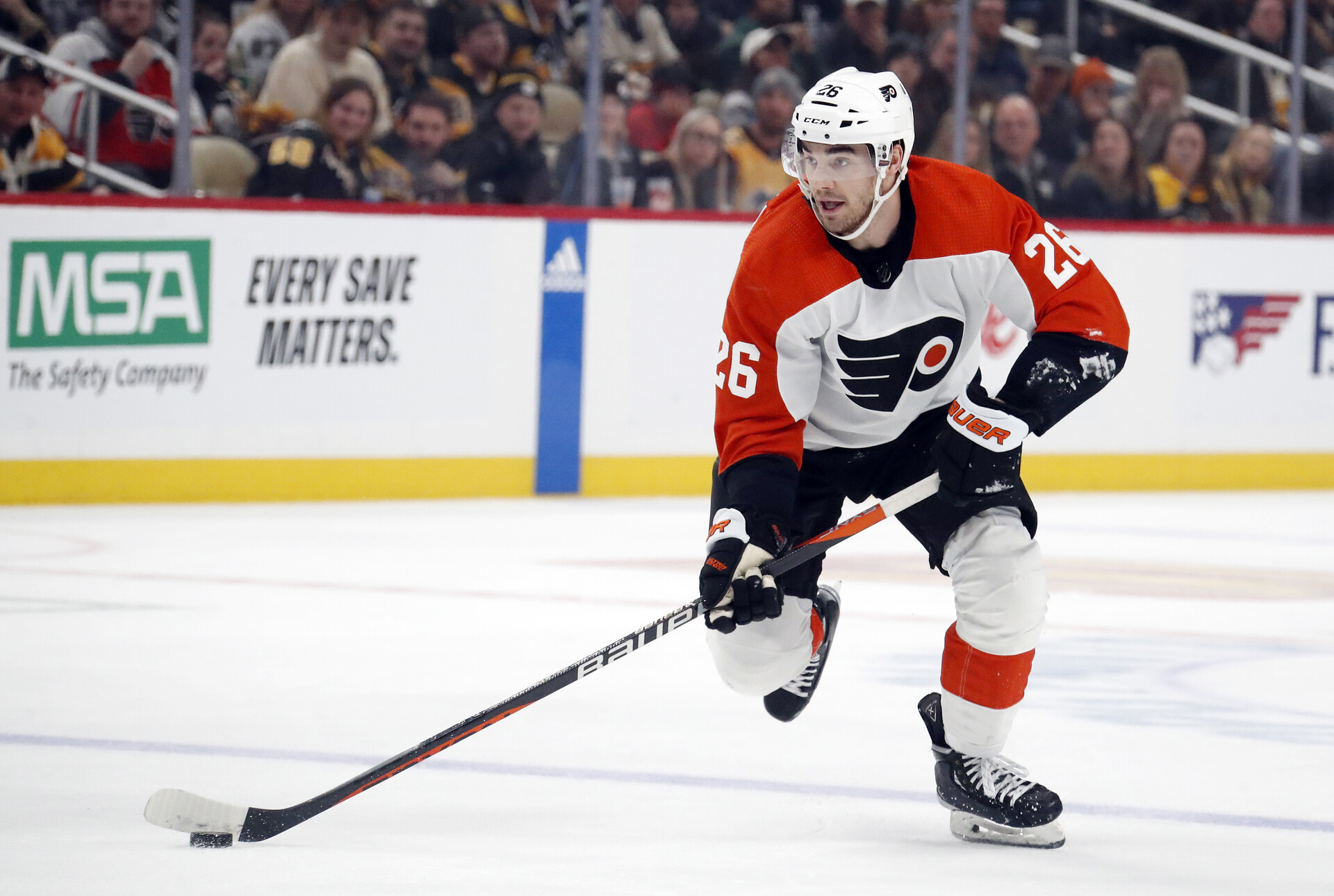 Philadelphia Flyers defenseman Sean Walker (26) skates with the puck against the Pittsburgh Penguins during the second period at PPG Paints Arena.