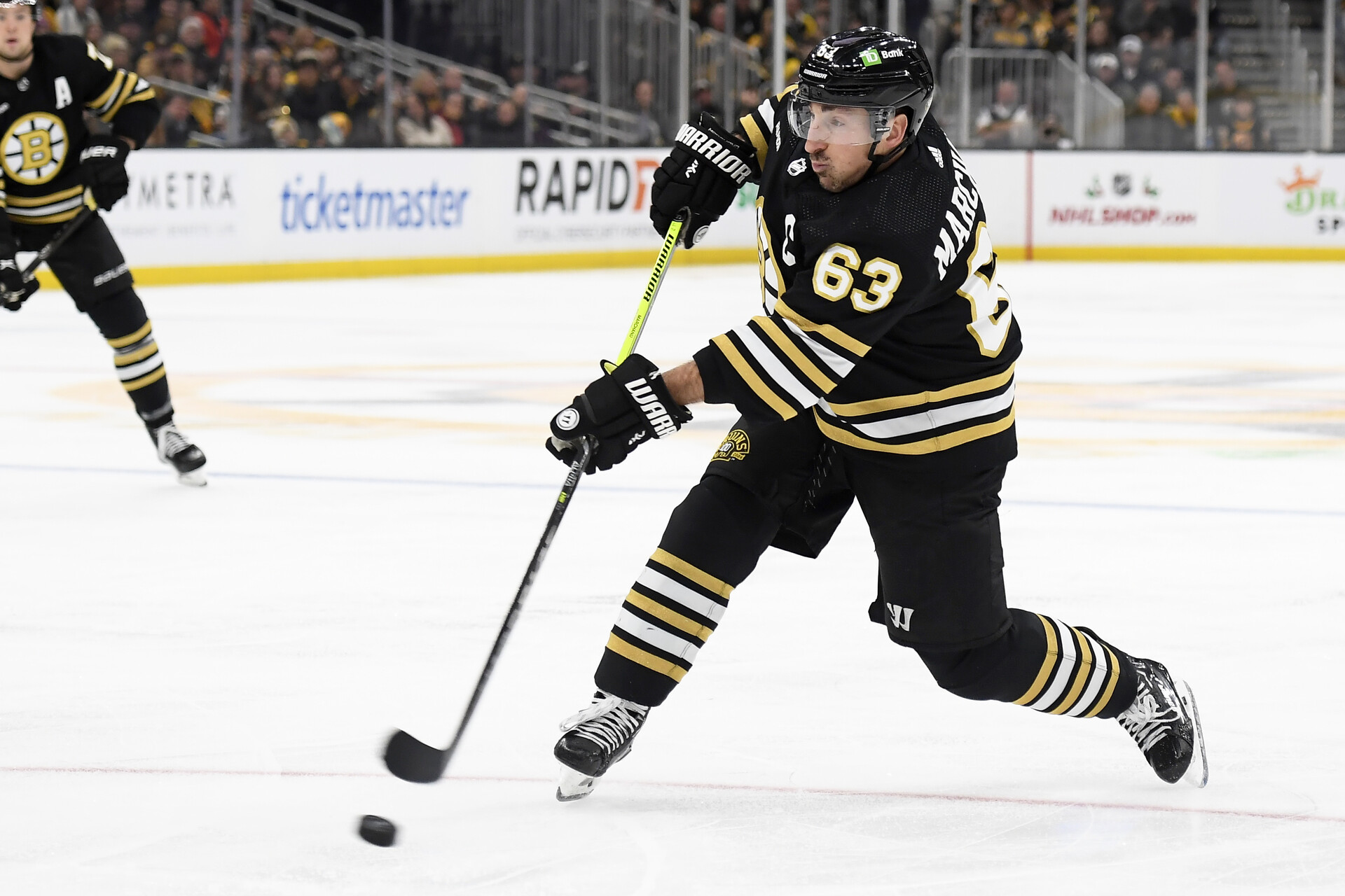 Dec 3, 2023; Boston, Massachusetts, USA; Boston Bruins left wing Brad Marchand (63) shoots the puck during the third period against the Columbus Blue Jackets at TD Garden.