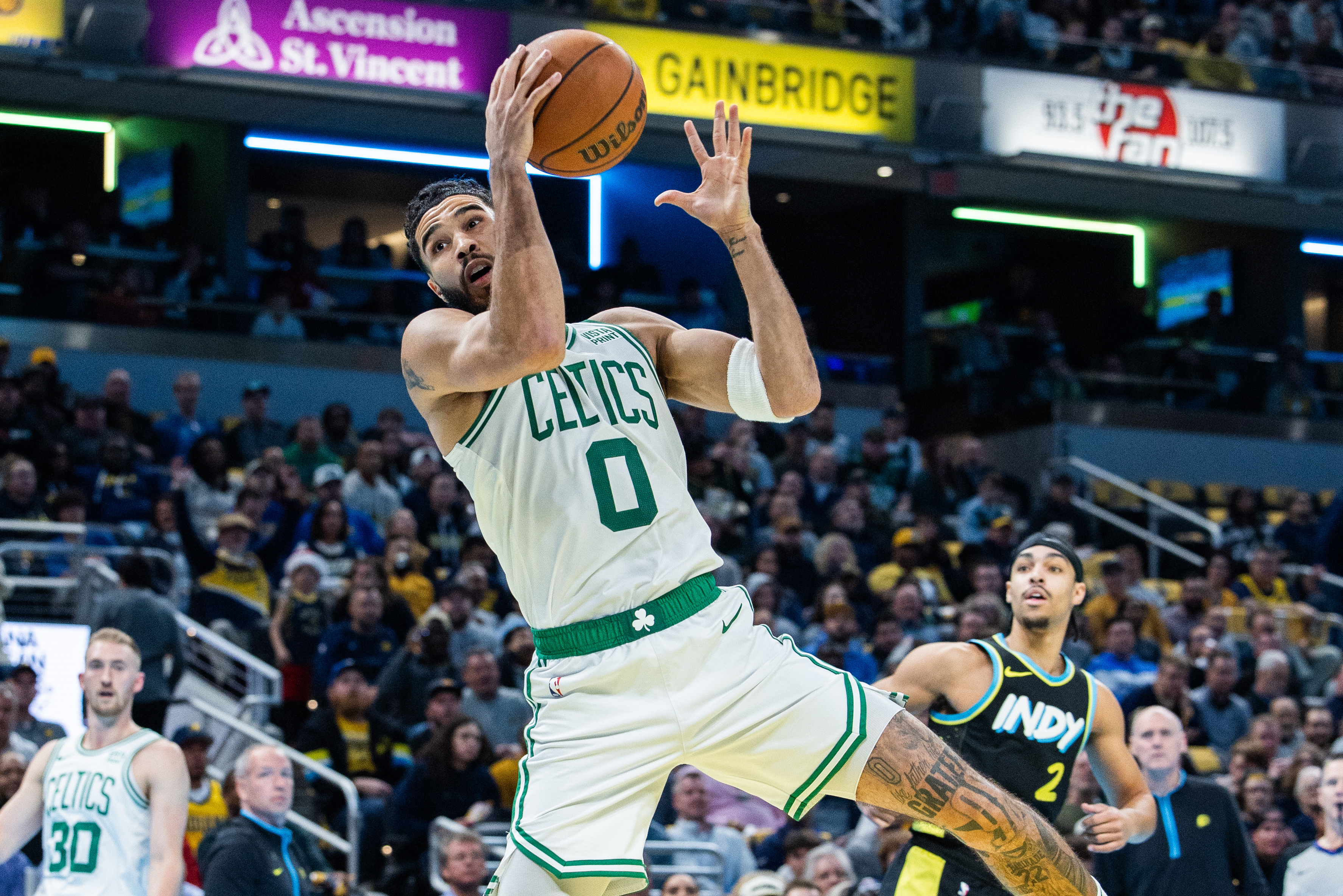 Dec 4, 2023; Indianapolis, Indiana, USA; Boston Celtics forward Jayson Tatum (0) rebounds the ball in the first half against the Indiana Pacers at Gainbridge Fieldhouse.