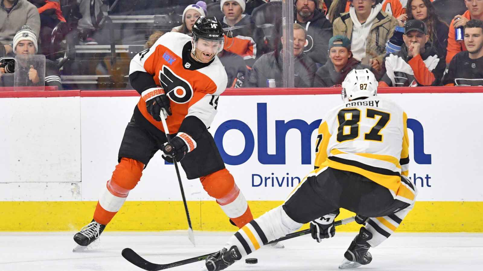 Dec 4, 2023; Philadelphia, Pennsylvania, USA; Philadelphia Flyers center Sean Couturier (14) and Pittsburgh Penguins center Sidney Crosby (87) battle for the puck during the third period at Wells Fargo Center.