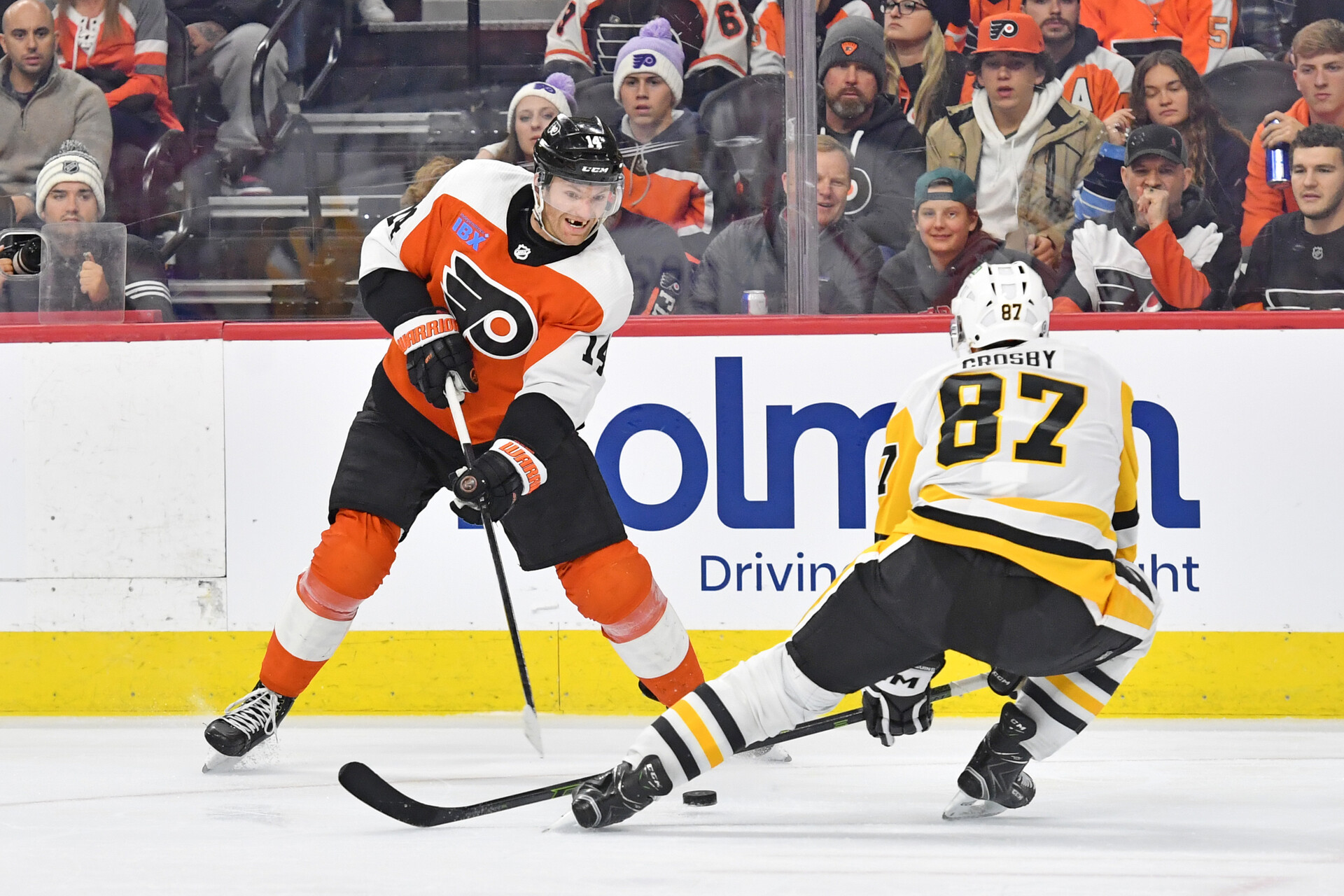 Dec 4, 2023; Philadelphia, Pennsylvania, USA; Philadelphia Flyers center Sean Couturier (14) and Pittsburgh Penguins center Sidney Crosby (87) battle for the puck during the third period at Wells Fargo Center.