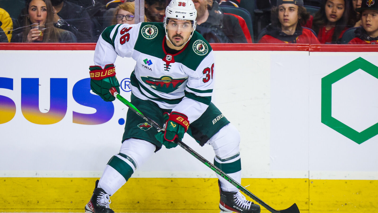 Dec 5, 2023; Calgary, Alberta, CAN; Minnesota Wild right wing Mats Zuccarello (36) controls the puck against the Calgary Flames during the first period at Scotiabank Saddledome