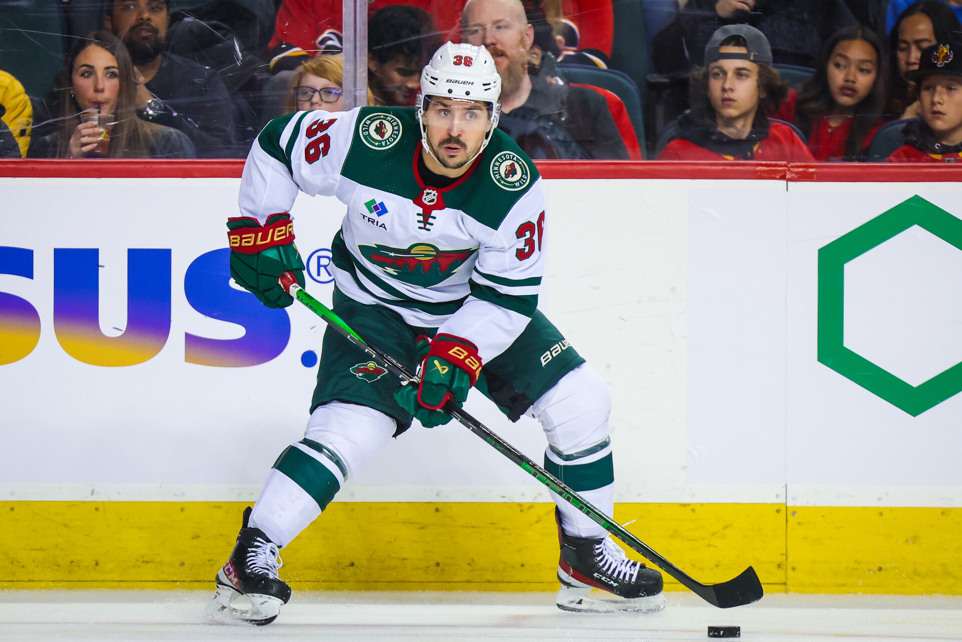 Dec 5, 2023; Calgary, Alberta, CAN; Minnesota Wild right wing Mats Zuccarello (36) controls the puck against the Calgary Flames during the first period at Scotiabank Saddledome
