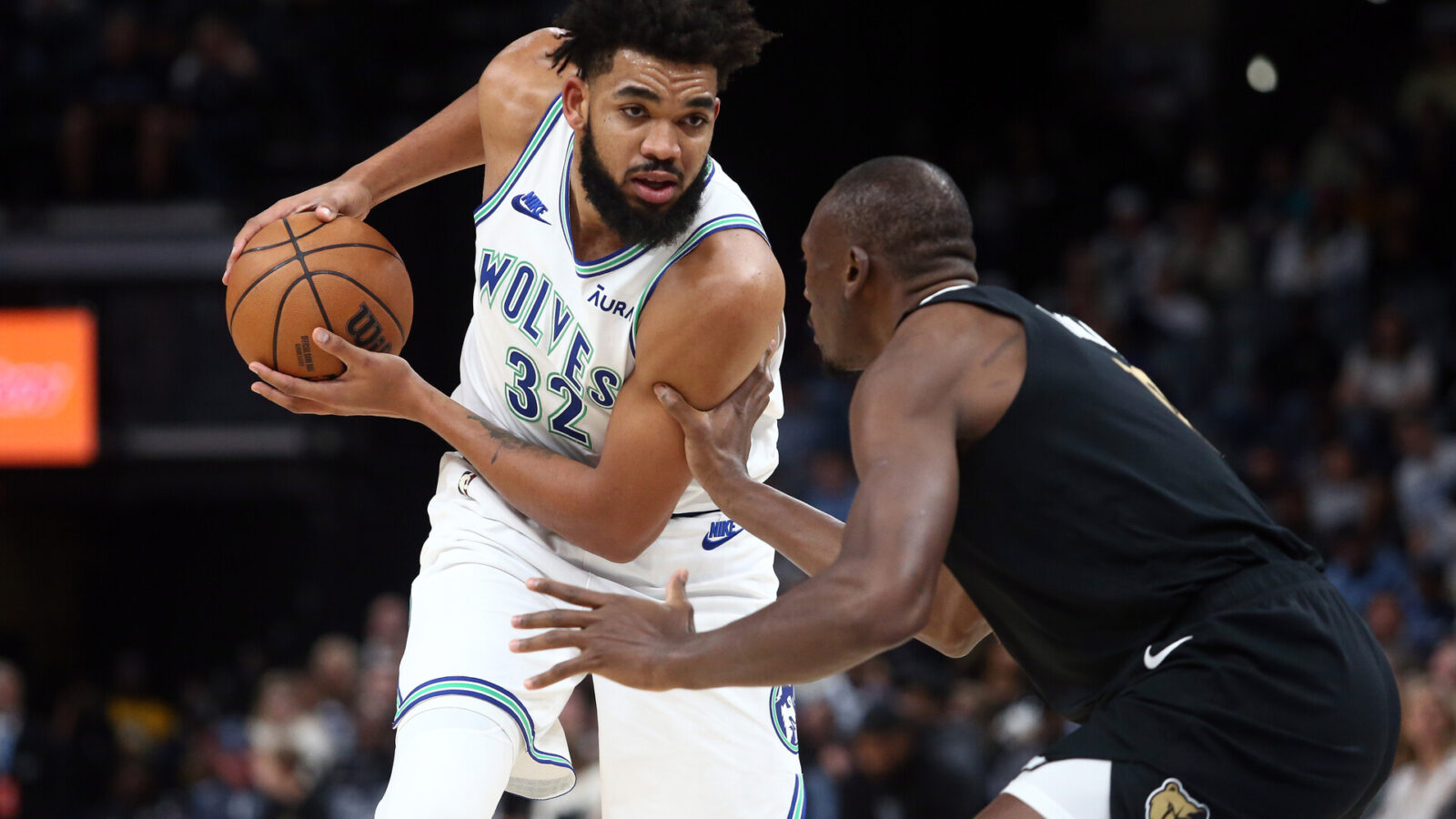 Minnesota Timberwolves center-forward Karl-Anthony Towns (32) handles the ball as Memphis Grizzlies center Bismack Biyombo (18) defends during the first half at FedExForum.