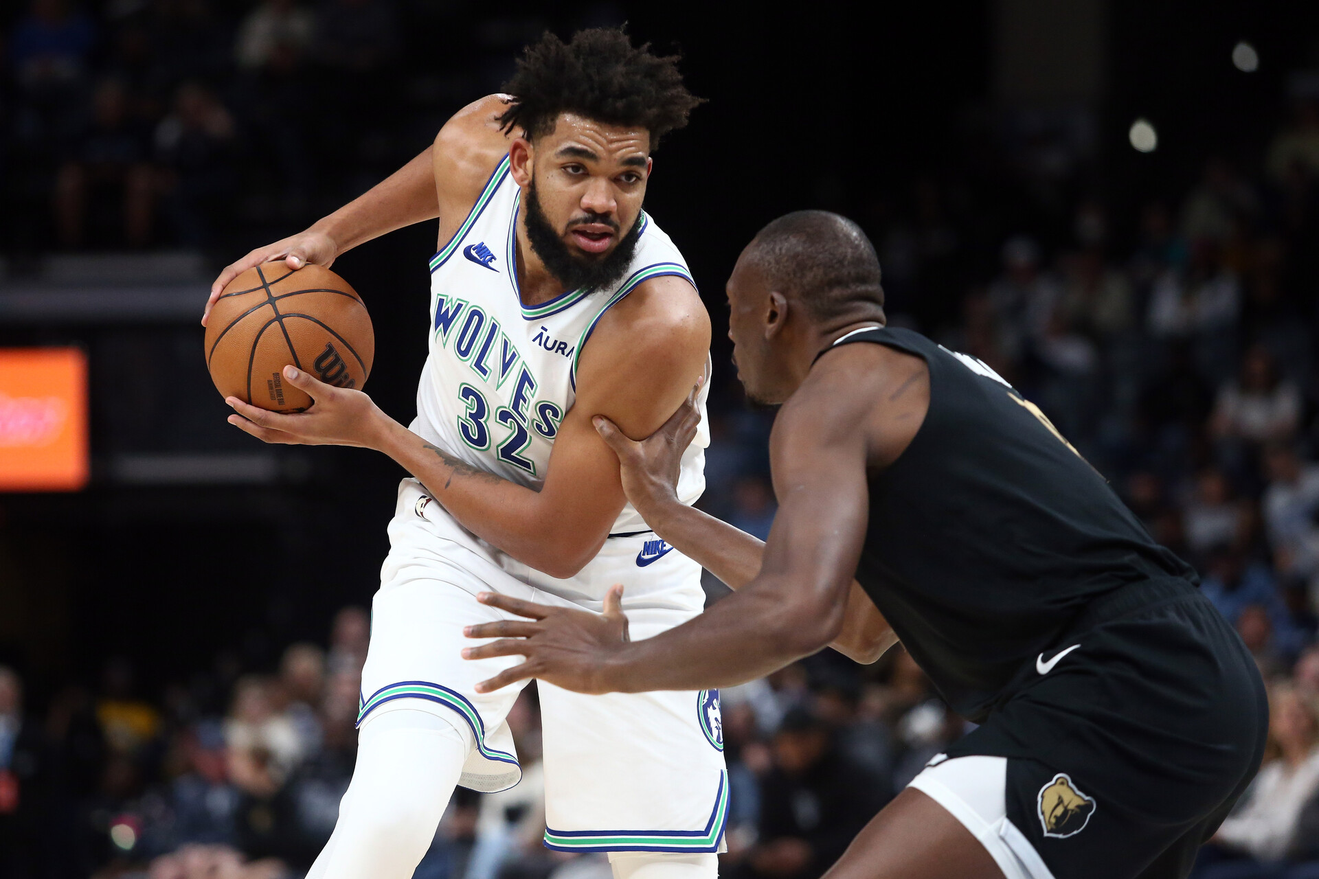 Minnesota Timberwolves center-forward Karl-Anthony Towns (32) handles the ball as Memphis Grizzlies center Bismack Biyombo (18) defends during the first half at FedExForum.