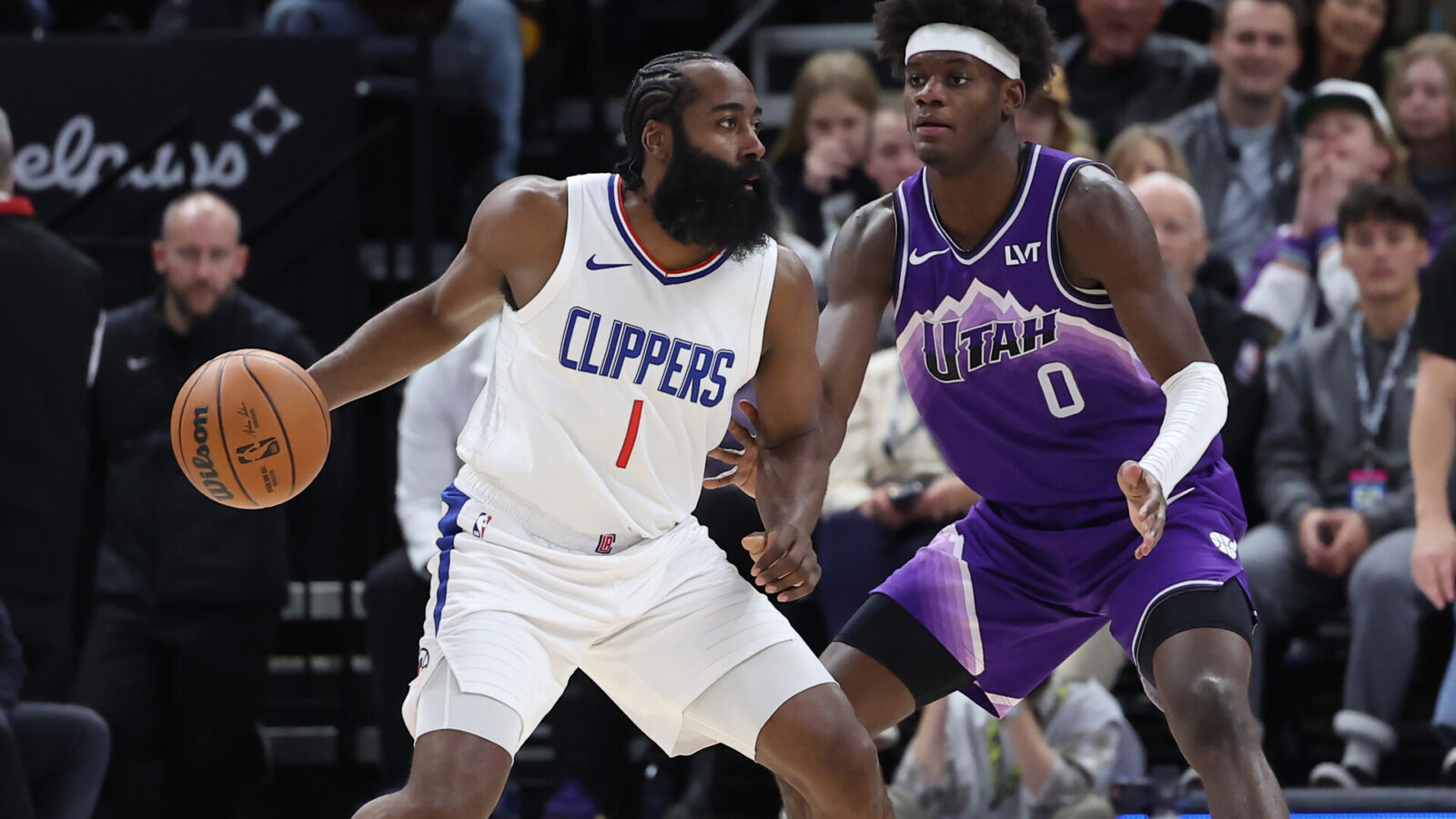 Dec 8, 2023; Salt Lake City, Utah, USA; Los Angeles Clippers guard James Harden (1) moves the ball against Utah Jazz forward Taylor Hendricks (0) during the second quarter at Delta Center.