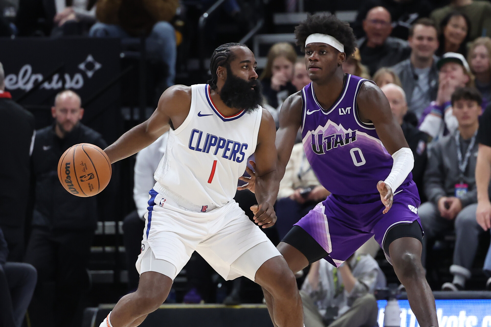 Dec 8, 2023; Salt Lake City, Utah, USA; Los Angeles Clippers guard James Harden (1) moves the ball against Utah Jazz forward Taylor Hendricks (0) during the second quarter at Delta Center.