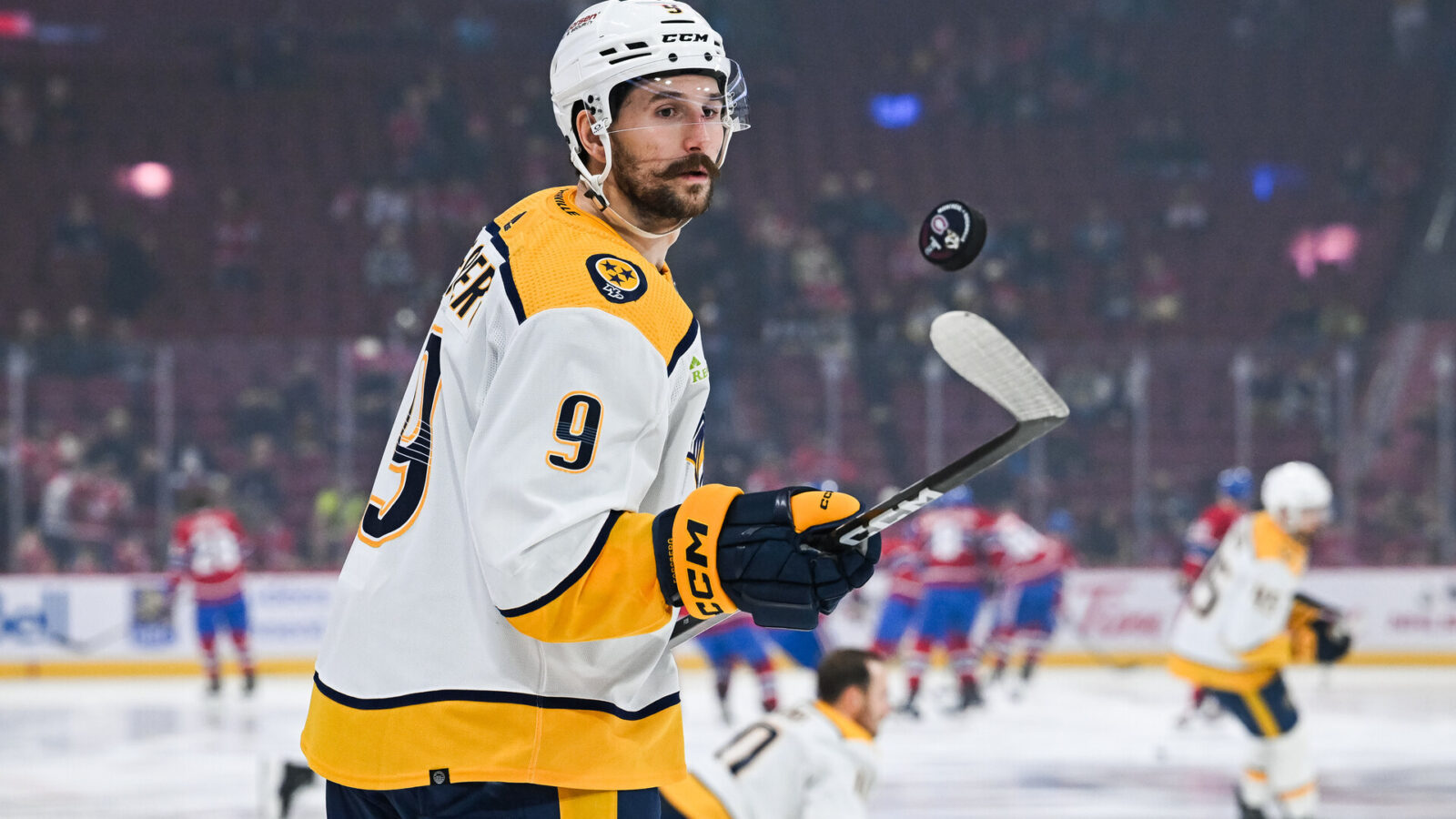Dec 10, 2023; Montreal, Quebec, CAN; Nashville Predators left wing Filip Forsberg (9) plays with a puck during warm-up before the game against the Montreal Canadiens at Bell Centre.