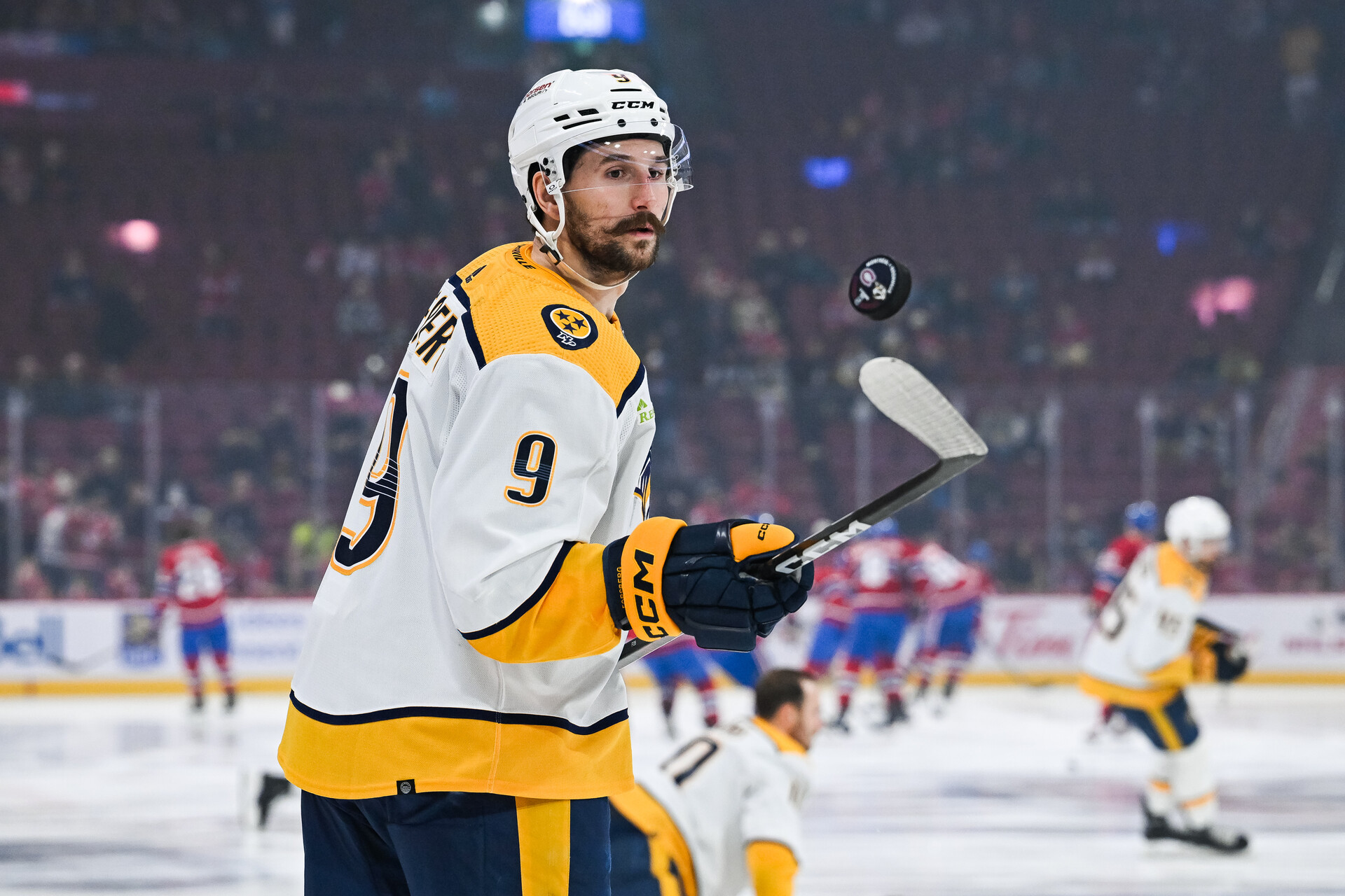 Dec 10, 2023; Montreal, Quebec, CAN; Nashville Predators left wing Filip Forsberg (9) plays with a puck during warm-up before the game against the Montreal Canadiens at Bell Centre.