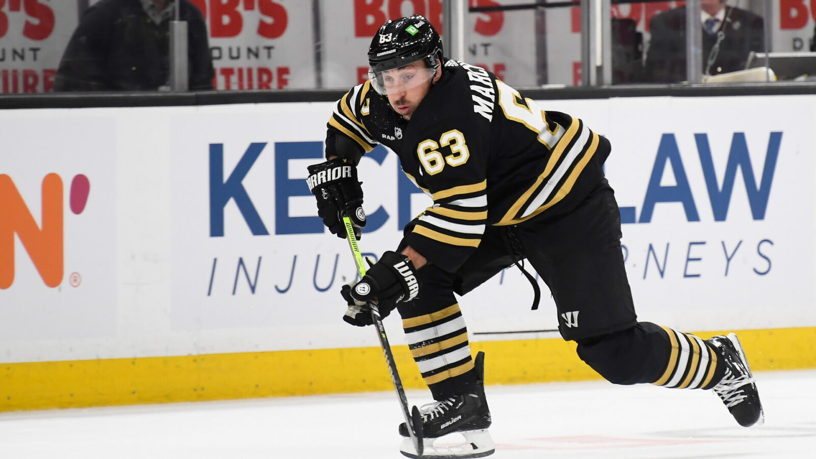 Dec 9, 2023; Boston, Massachusetts, USA; Boston Bruins left wing Brad Marchand (63) skates with the puck during the first period against the Arizona Coyotes at TD Garden.