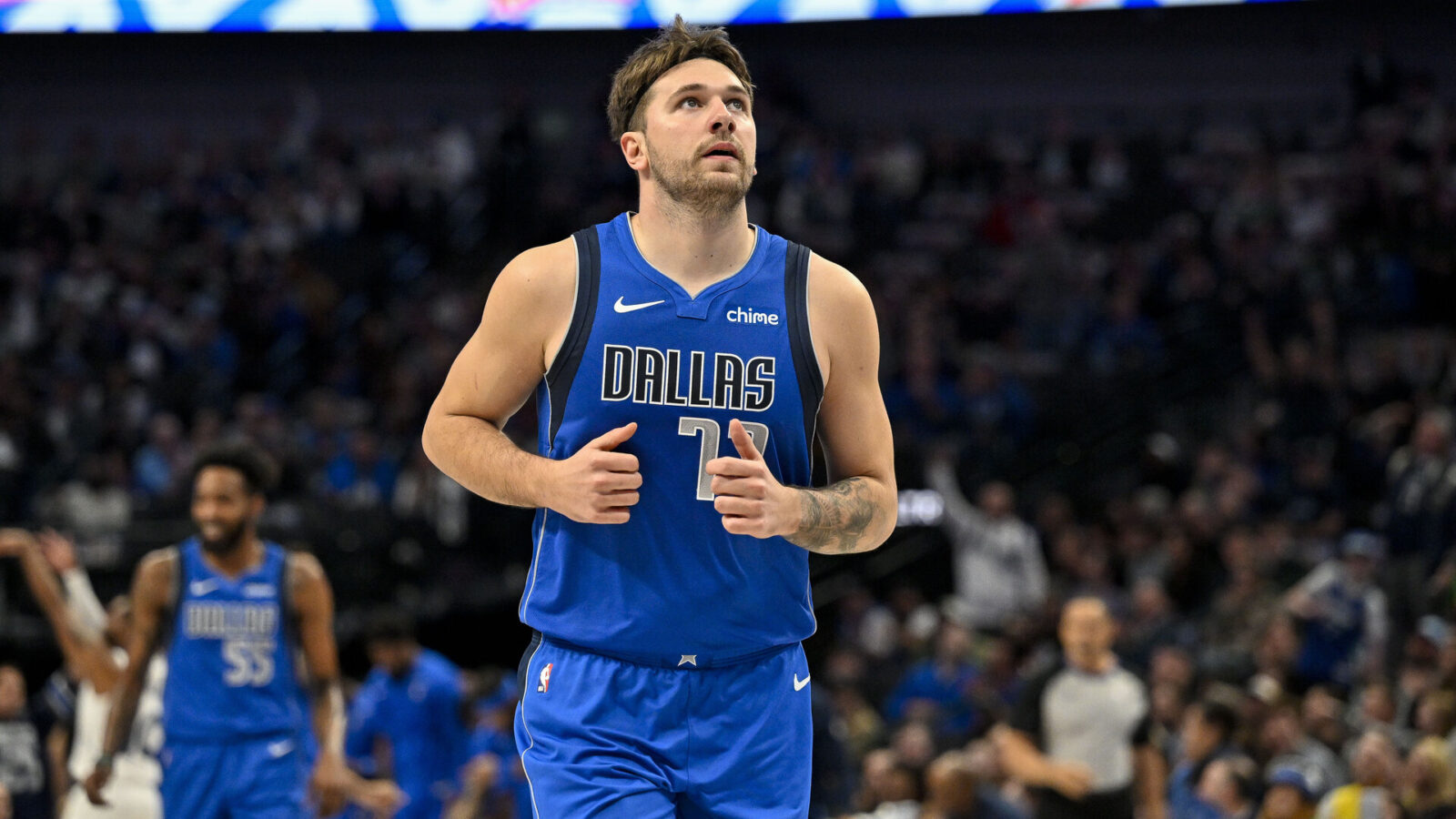 Dec 14, 2023; Dallas, Texas, USA; Dallas Mavericks guard Luka Doncic (77) runs back up the court after making a three point shot against the Minnesota Timberwolves during the first quarter at the American Airlines Center.