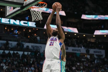 Dec 16, 2023; Charlotte, North Carolina, USA; Philadelphia 76ers center Joel Embiid (21) scores on a layup against Charlotte Hornets center Nick Richards (4) during the second quarter at Spectrum Center.