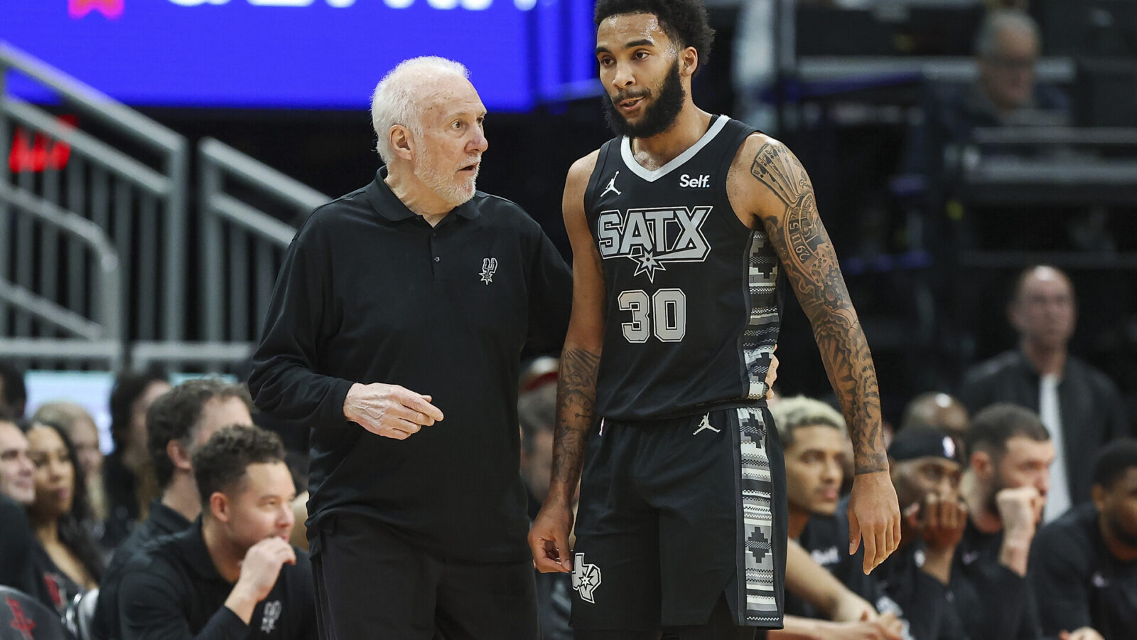 San Antonio Spurs head coach Gregg Popovich talks with forward Julian Champagnie (30) during the first quarter against the Houston Rockets at Toyota Center.