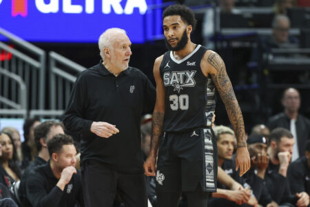 San Antonio Spurs head coach Gregg Popovich talks with forward Julian Champagnie (30) during the first quarter against the Houston Rockets at Toyota Center.