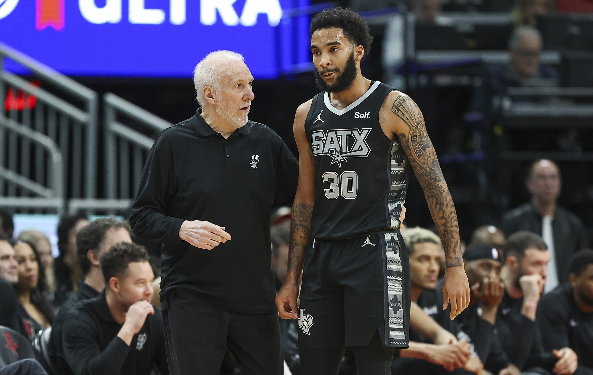 San Antonio Spurs head coach Gregg Popovich talks with forward Julian Champagnie (30) during the first quarter against the Houston Rockets at Toyota Center.