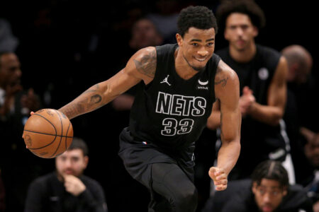 Brooklyn Nets center Nic Claxton (33) brings the ball up court against the Denver Nuggets during the fourth quarter at Barclays Center.