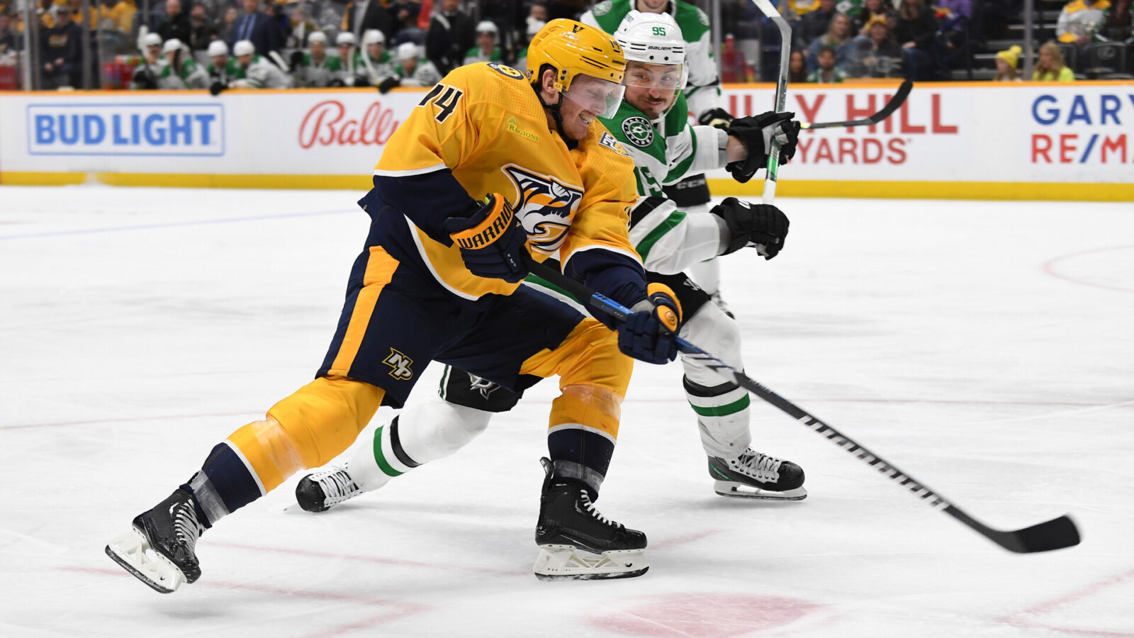 Dec 23, 2023; Nashville, Tennessee, USA; Nashville Predators center Gustav Nyquist (14) handles the puck against Dallas Stars center Matt Duchene (95) during the third period at Bridgestone Arena.