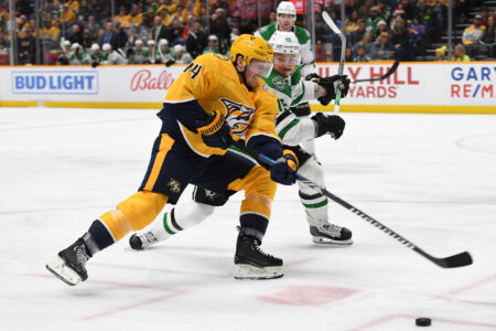 Dec 23, 2023; Nashville, Tennessee, USA; Nashville Predators center Gustav Nyquist (14) handles the puck against Dallas Stars center Matt Duchene (95) during the third period at Bridgestone Arena.