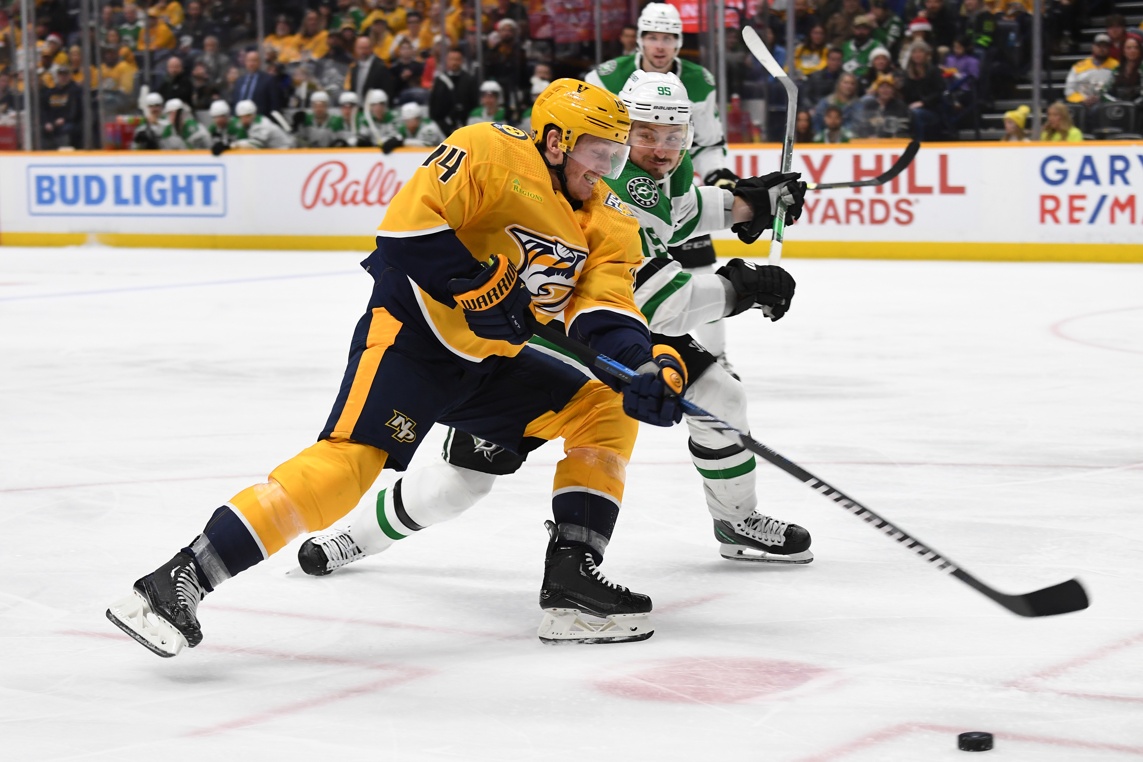 Dec 23, 2023; Nashville, Tennessee, USA; Nashville Predators center Gustav Nyquist (14) handles the puck against Dallas Stars center Matt Duchene (95) during the third period at Bridgestone Arena.