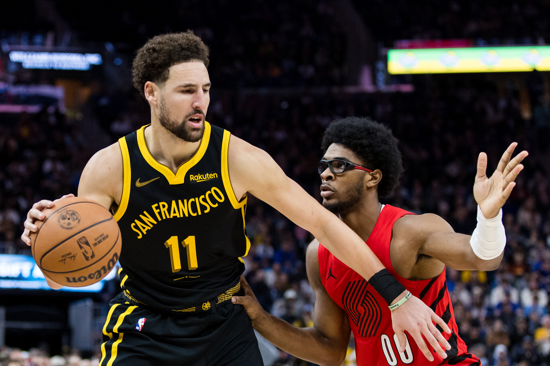 Portland Trail Blazers guard Scoot Henderson (00) defends Golden State Warriors forward Klay Thompson (11) during the second half at Chase Center.