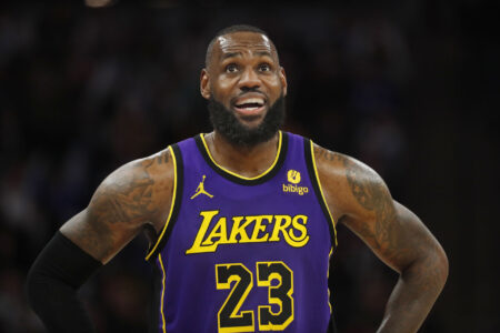 Los Angeles Lakers forward LeBron James (23) looks to the replay board as he awaits play to resume against the Minnesota Timberwolves in the third quarter at Target Center.