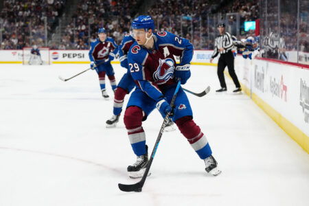 Jan 2, 2024; Denver, Colorado, USA; Colorado Avalanche center Nathan MacKinnon (29) controls the puck in overtime against the New York Islanders at Ball Arena.