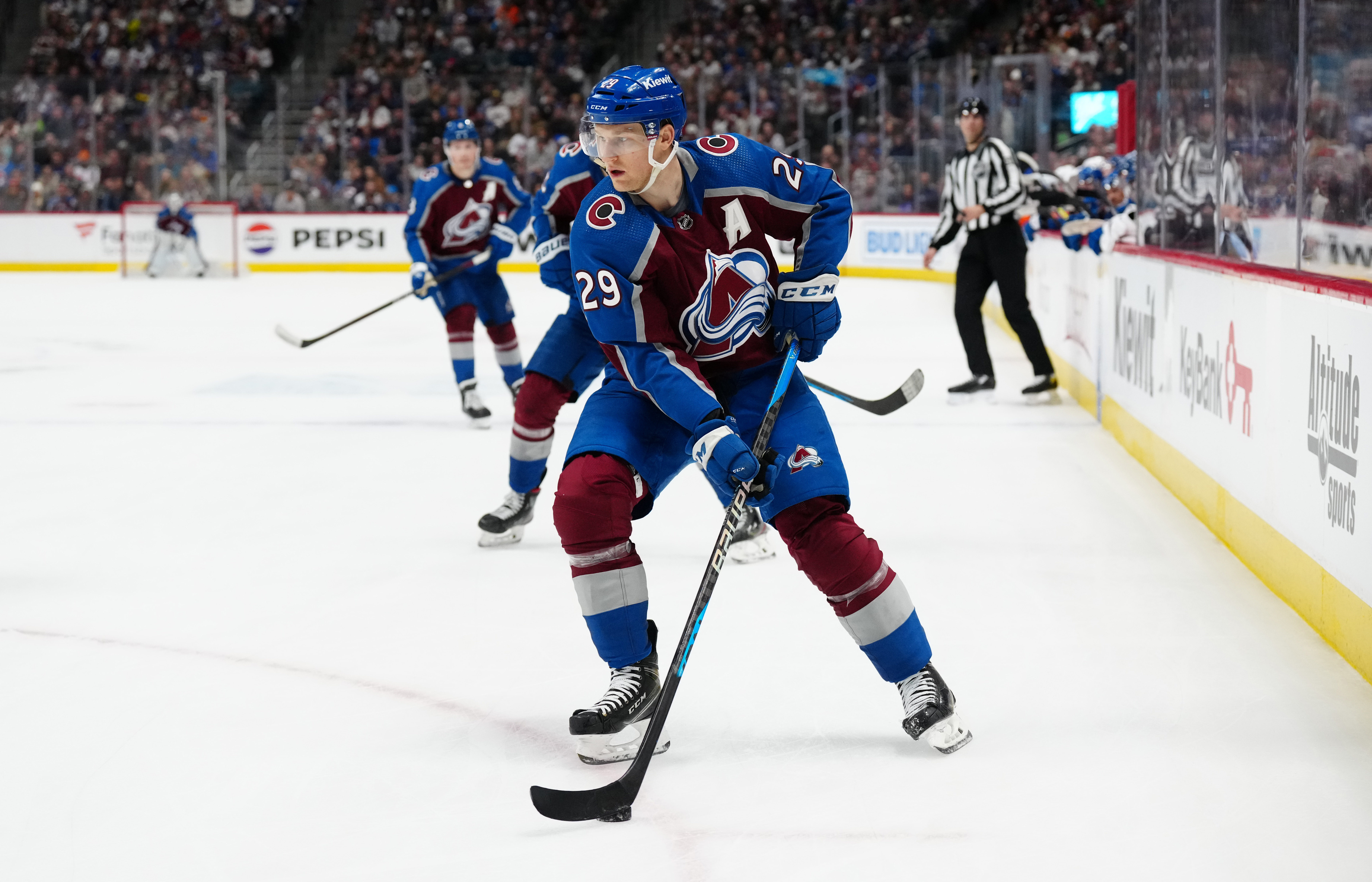 Jan 2, 2024; Denver, Colorado, USA; Colorado Avalanche center Nathan MacKinnon (29) controls the puck in overtime against the New York Islanders at Ball Arena.