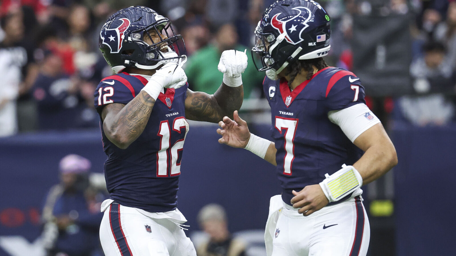 Jan 13, 2024; Houston, Texas, USA; Houston Texans wide receiver Nico Collins (12) celebrates with quarterback C.J. Stroud (7) after a touchdown in a 2024 AFC wild card game against the Cleveland Browns at NRG Stadium.