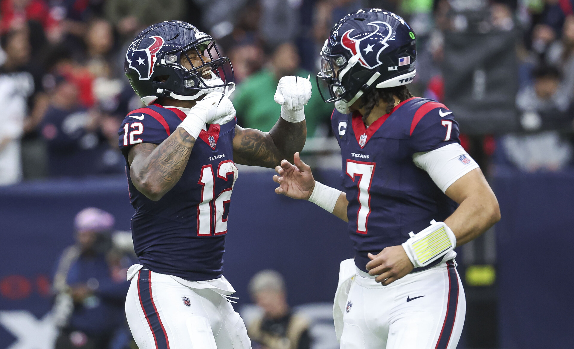 Jan 13, 2024; Houston, Texas, USA; Houston Texans wide receiver Nico Collins (12) celebrates with quarterback C.J. Stroud (7) after a touchdown in a 2024 AFC wild card game against the Cleveland Browns at NRG Stadium.