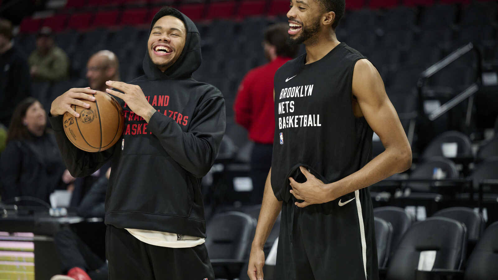 Jan 17, 2024; Portland, Oregon, USA; Portland Trail Blazers guard Anfernee Simons (1), left, and Brooklyn Nets forward Mikal Bridges (1) laugh while visiting each other during warm ups before a game at Moda Center.