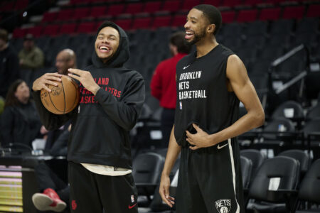 Jan 17, 2024; Portland, Oregon, USA; Portland Trail Blazers guard Anfernee Simons (1), left, and Brooklyn Nets forward Mikal Bridges (1) laugh while visiting each other during warm ups before a game at Moda Center.