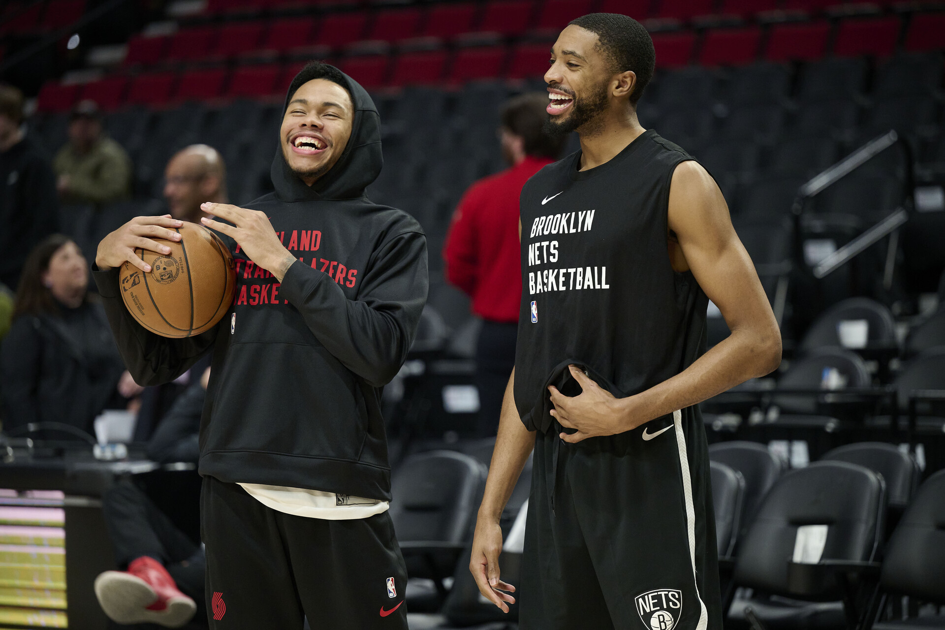 Jan 17, 2024; Portland, Oregon, USA; Portland Trail Blazers guard Anfernee Simons (1), left, and Brooklyn Nets forward Mikal Bridges (1) laugh while visiting each other during warm ups before a game at Moda Center.