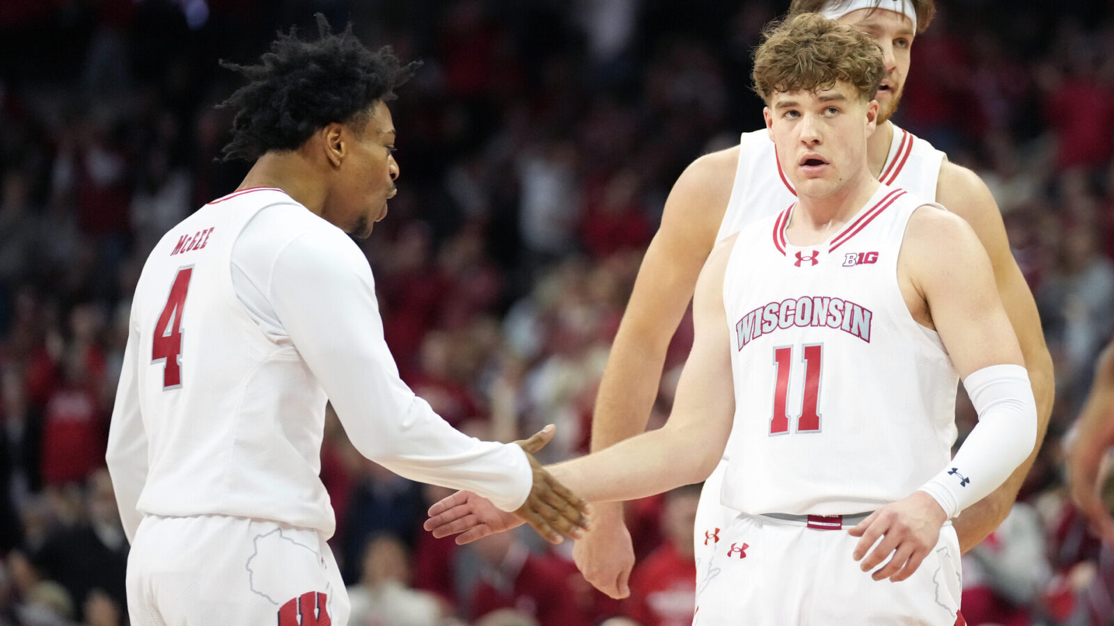 Wisconsin Badgers guard Max Klesmit (11) celebrates a three point basket with Wisconsin Badgers guard Kamari McGee (4) during the second half against the Indiana Hoosiers at the Kohl Center.