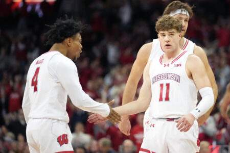 Wisconsin Badgers guard Max Klesmit (11) celebrates a three point basket with Wisconsin Badgers guard Kamari McGee (4) during the second half against the Indiana Hoosiers at the Kohl Center.