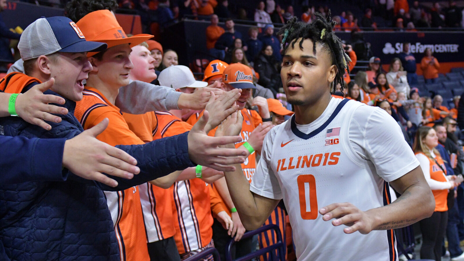 Illinois Fighting Illini guard Terrence Shannon Jr. (0) gets a hand from the fans after a 86-63 game win over the Rutgers Scarlet Knights at State Farm Center.